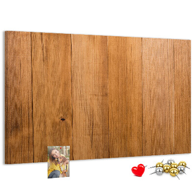 Prikbord van hout met gekleurde pinnen