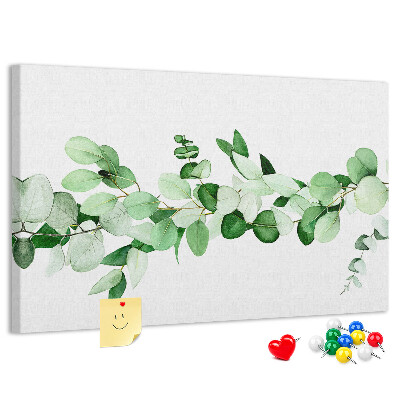 Prikbord met groene bladeren op een lichte achtergrond