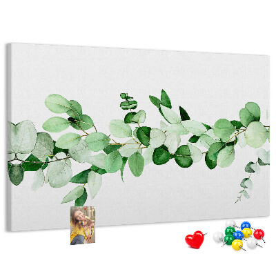 Prikbord met groene bladeren op een lichte achtergrond