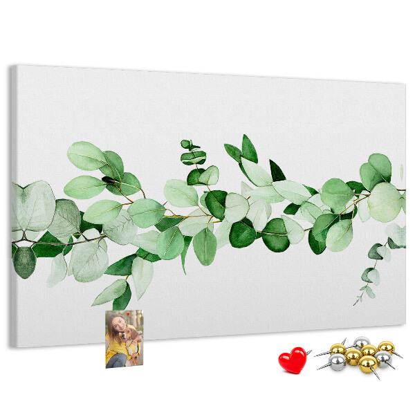 Prikbord met groene bladeren op een lichte achtergrond