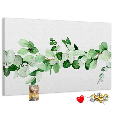 Prikbord met groene bladeren op een lichte achtergrond