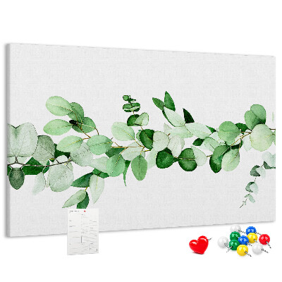 Prikbord met groene bladeren op een lichte achtergrond