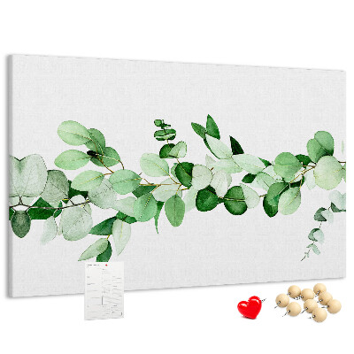 Prikbord met groene bladeren op een lichte achtergrond