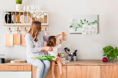 Prikbord met groene bladeren op een lichte achtergrond