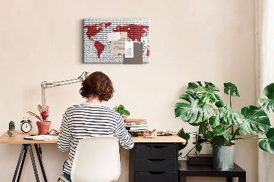 Kurkbord met afbeelding van de wereld op een bakstenen muur