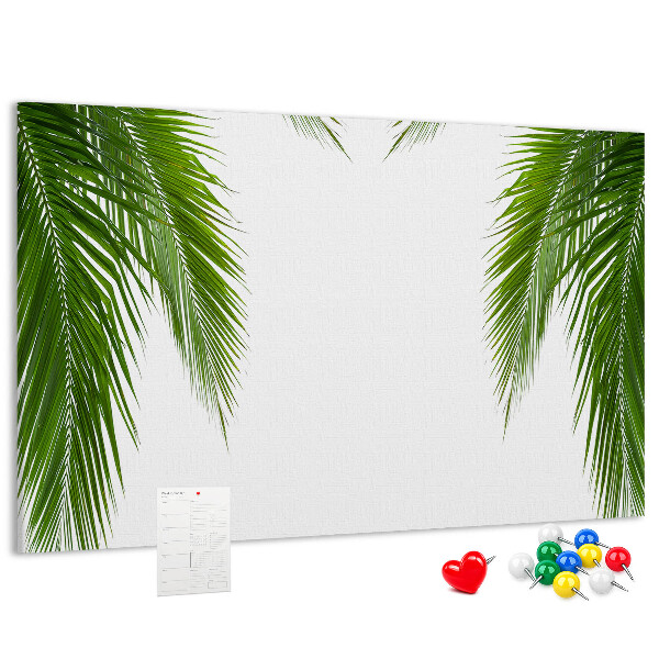Prikbord met een print van palmbladeren op een witte achtergrond