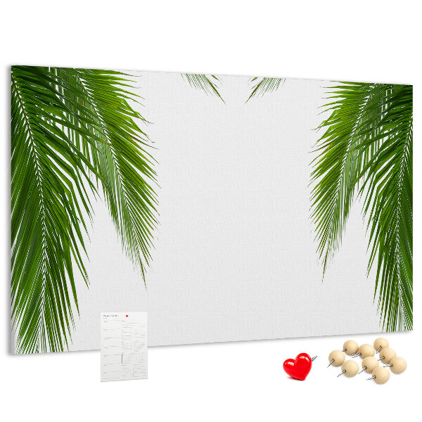 Prikbord met een print van palmbladeren op een witte achtergrond