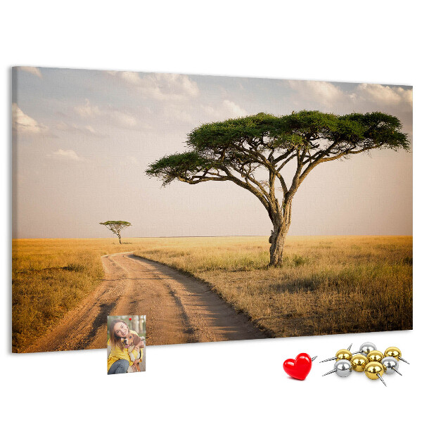 Prikbord met een Afrikaans landschap van een weg met een boom