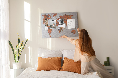 Kurkbord wereldkaart tegen een bakstenen muur